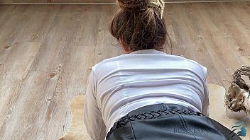 Secretary in sexy leather skirt kneels in front of her boss