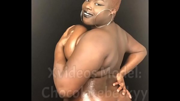 Ebony BBW rubbing oil on natural big tits and body